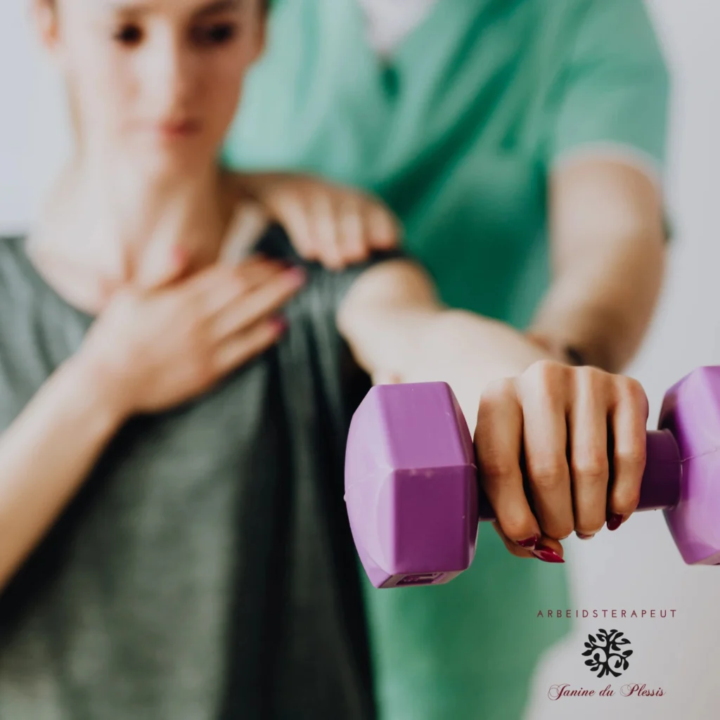 A physical therapist in green scrubs assisting a female patient with shoulder rehabilitation using a purple dumbbell.