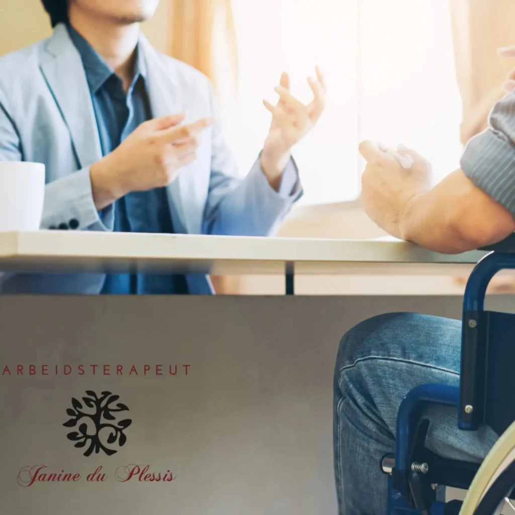 A man in a wheelchair consults with a professional across a desk, with an occupational therapist's logo visible.
